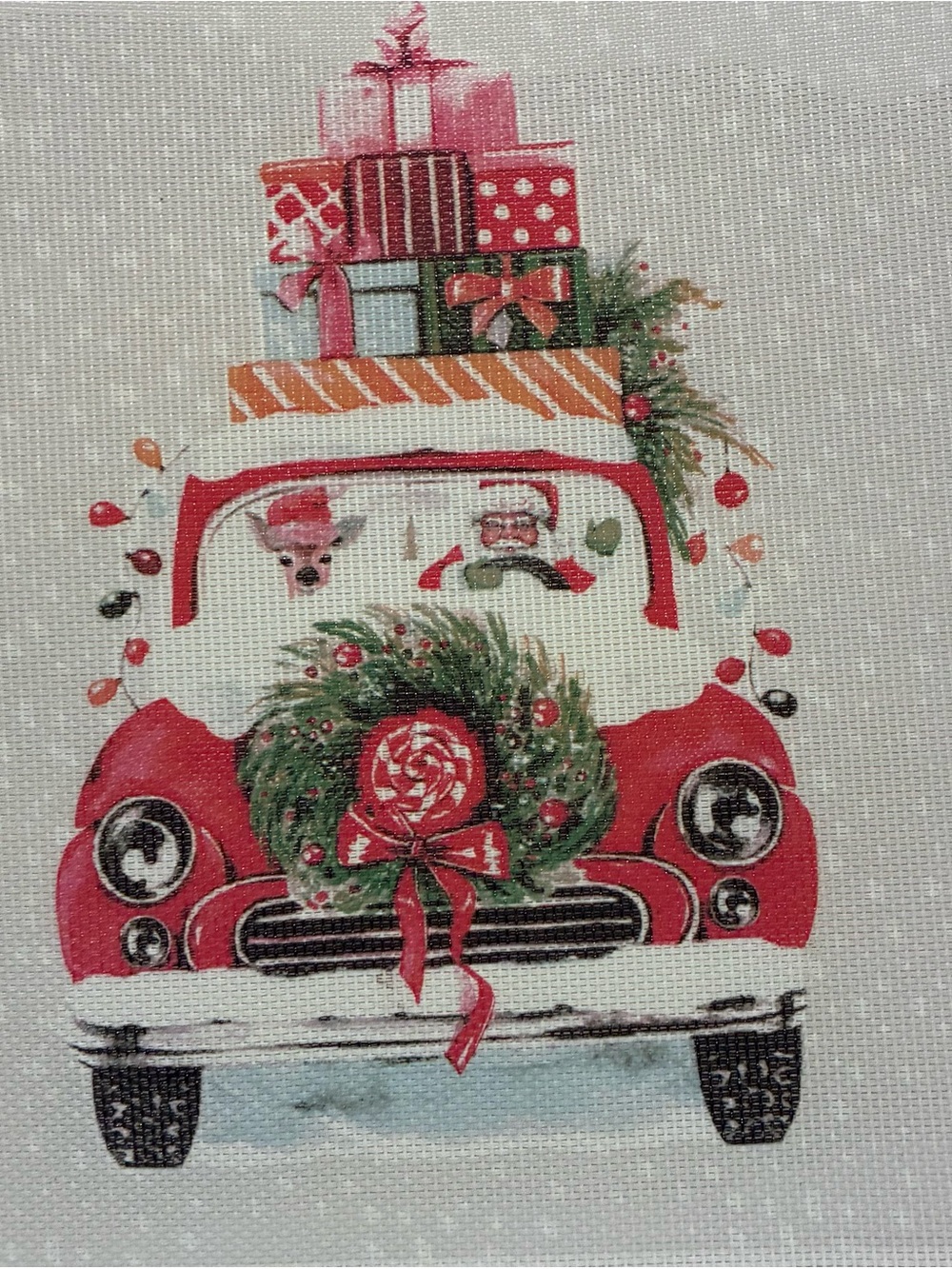 Christmas cross stitch kit with Santa and red truck.